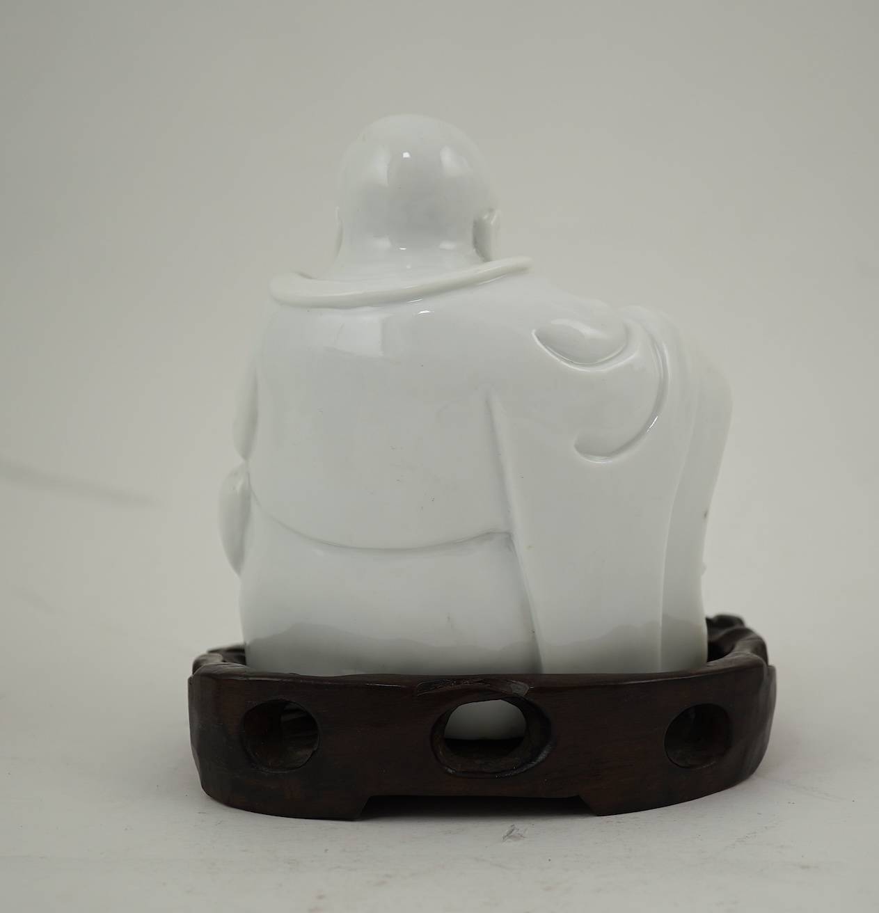 A Chinese blanc-de-chine seated figure of Budai, 18th/19th century